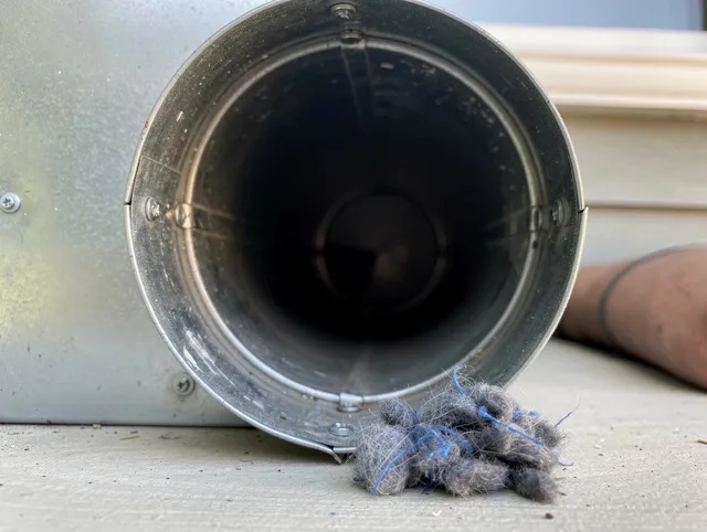 Hermosa Beach Dryer Vent Cleaning technician using specialized equipment to clear severe dryer vent blockage in Hermosa Beach